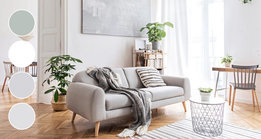 a gray couch in a living room decorated in cool neutrals